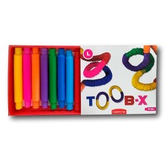 Caja abierta del juego de construcción TOOB-X Tamaño L mostrando ocho tubos sensoriales expandibles de colores brillantes