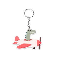 Llavero identificativo infantil de silicona de la colección Planes de con forma de cocodrilo verde en un avión blanco y rojo.